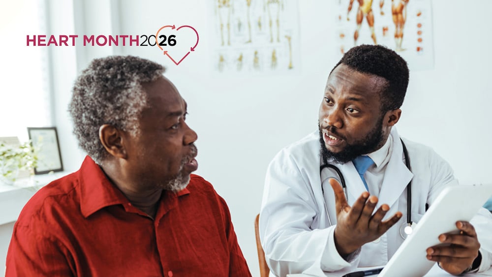 Older African American patient listening to African American cardiologist