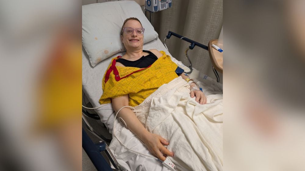 Janis Becker as a patient in a hospital bed in 2025