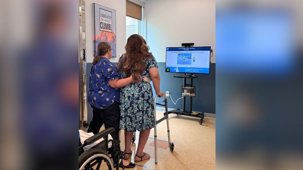 Occupational therapist helping rehab patient using Jintronix virtual reality