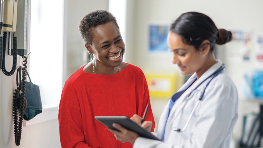 Female cardiologist explaining lipid panels to female patient