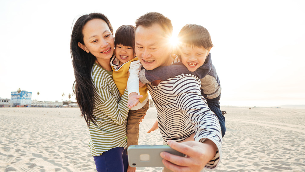 Family taking selfie at beach
