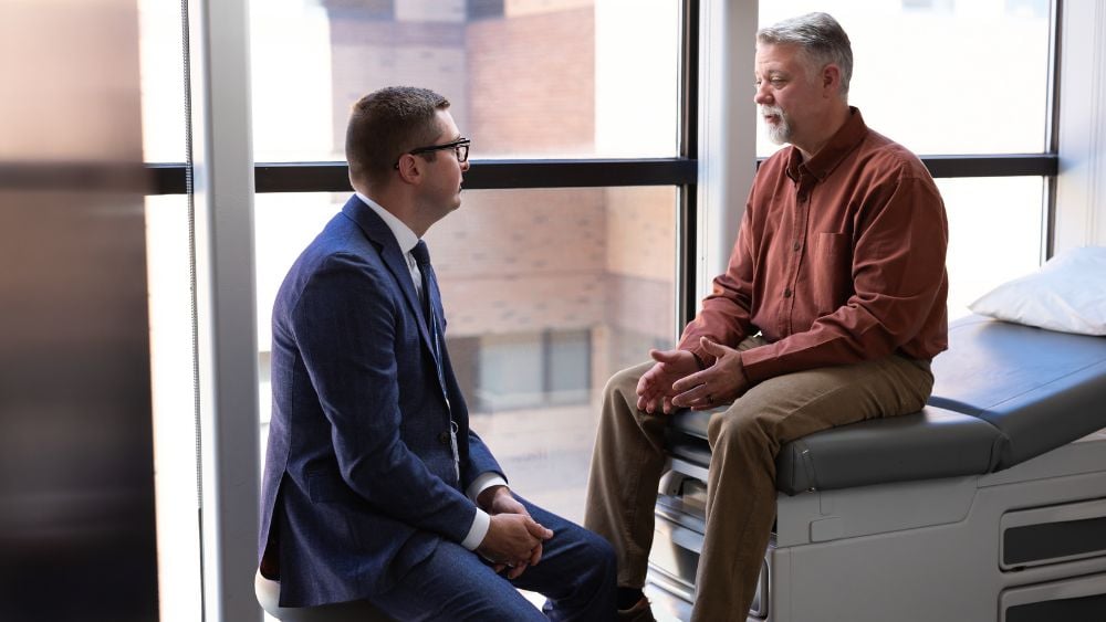 Dr. Ryan Lydon talking with male patient