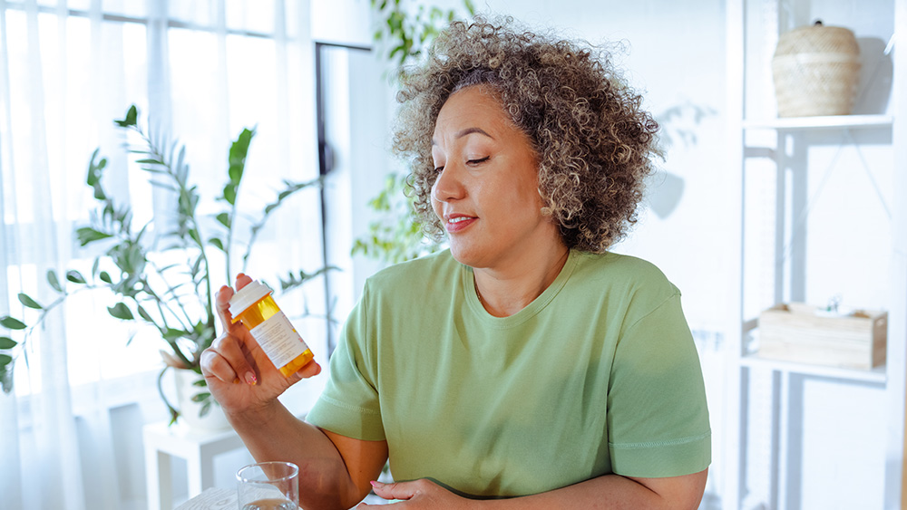 Woman looking at magnesium bottle