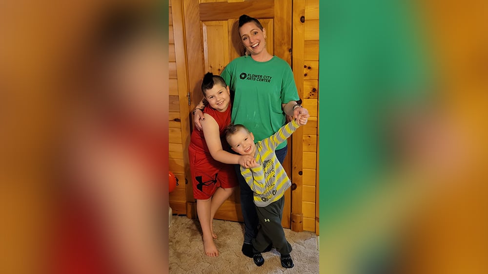Family photo of woman with mohawk and two young boys with mohawks