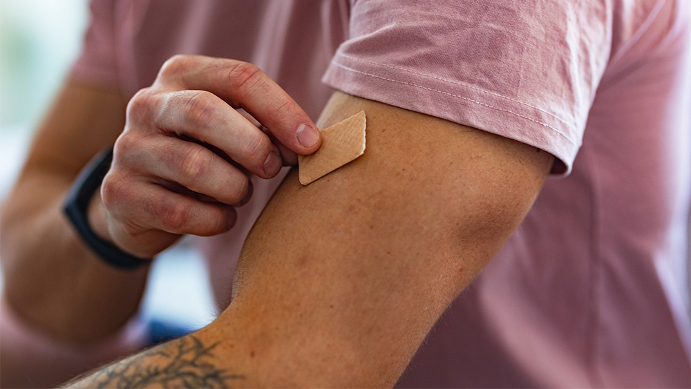 Man with nicotine patch on arm