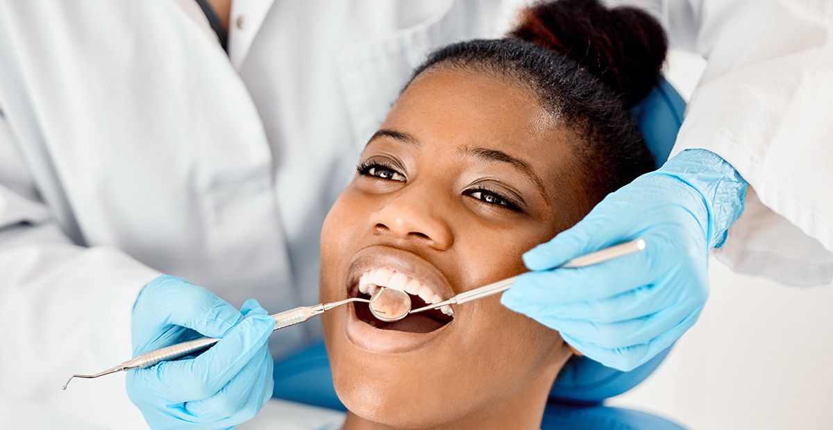 Shot of a young female patient having her teeth examined