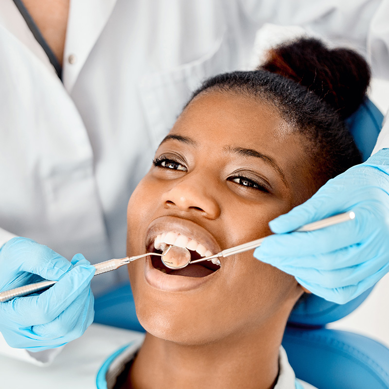 Shot of a young female patient having her teeth examined