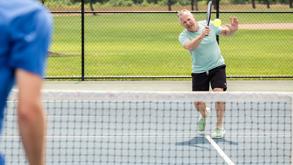 Man playing pickleball outdoors