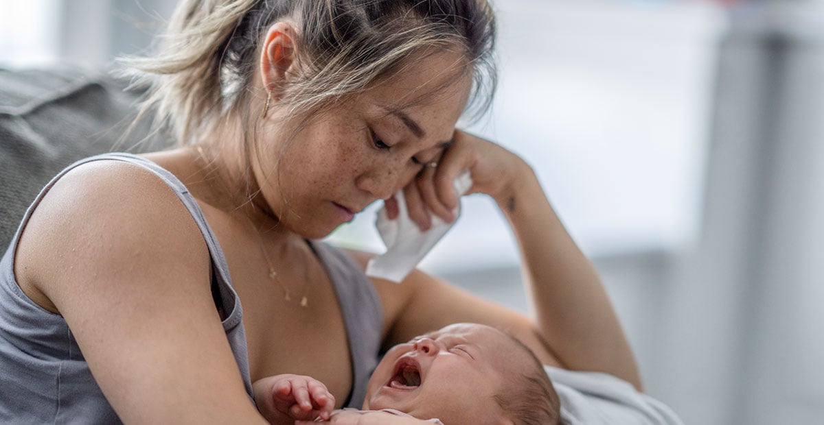 A tired mother with her infant child