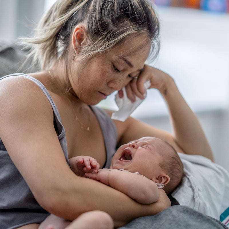 A tired mother with her infant child