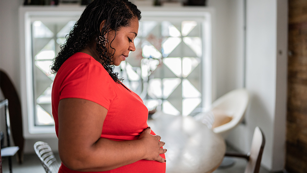 Pregnant African American woman at home