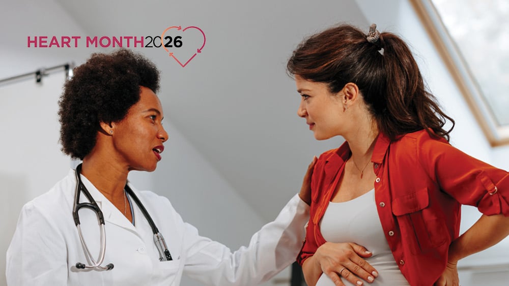 Female health provider talking with female pregnant patient