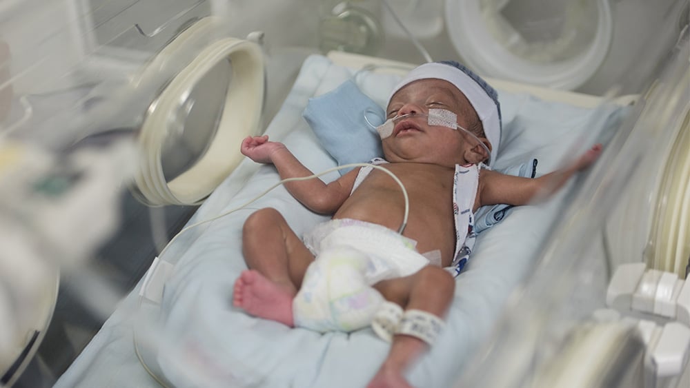 Beautiful newborn baby boy in the neonatal intensive care unit sleeping