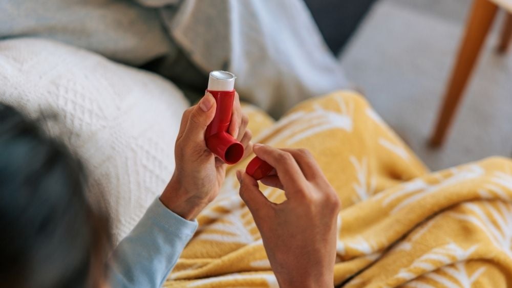 Person holding rescue inhaler