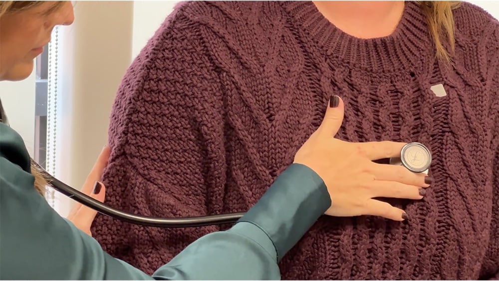 Doctor listening to patient heartbeat
