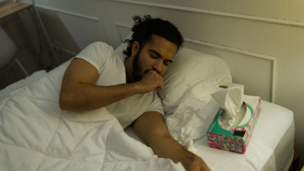 Man in bed with sinus infection