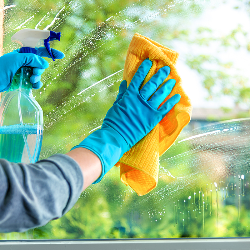 Cleaning window pane with detergent, spring cleaning concept