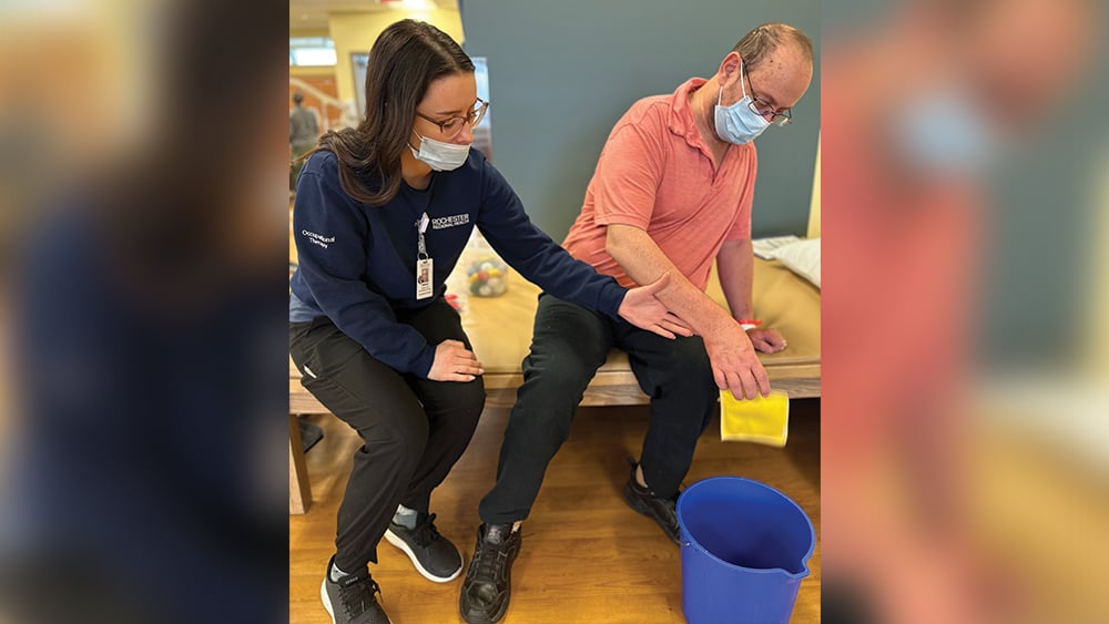 Sydney Jones and her patient Guy work on occupational therapy following a stroke