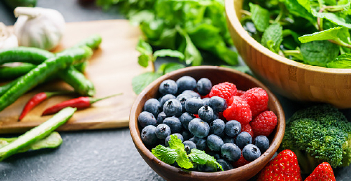 Wood bowls with mint blueberries raspberries broccoli sugar snap peas