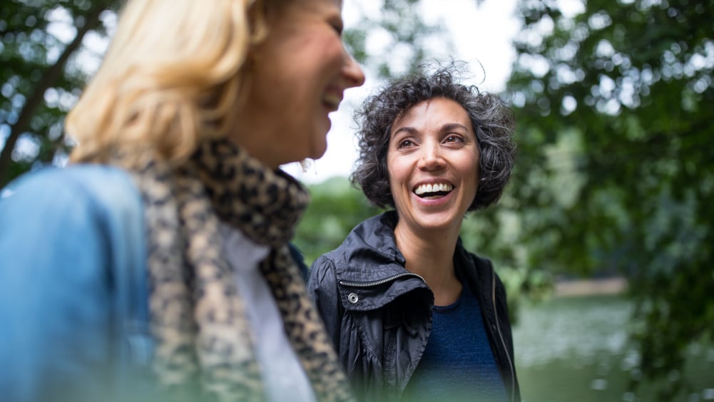 Two female friends walking outside
