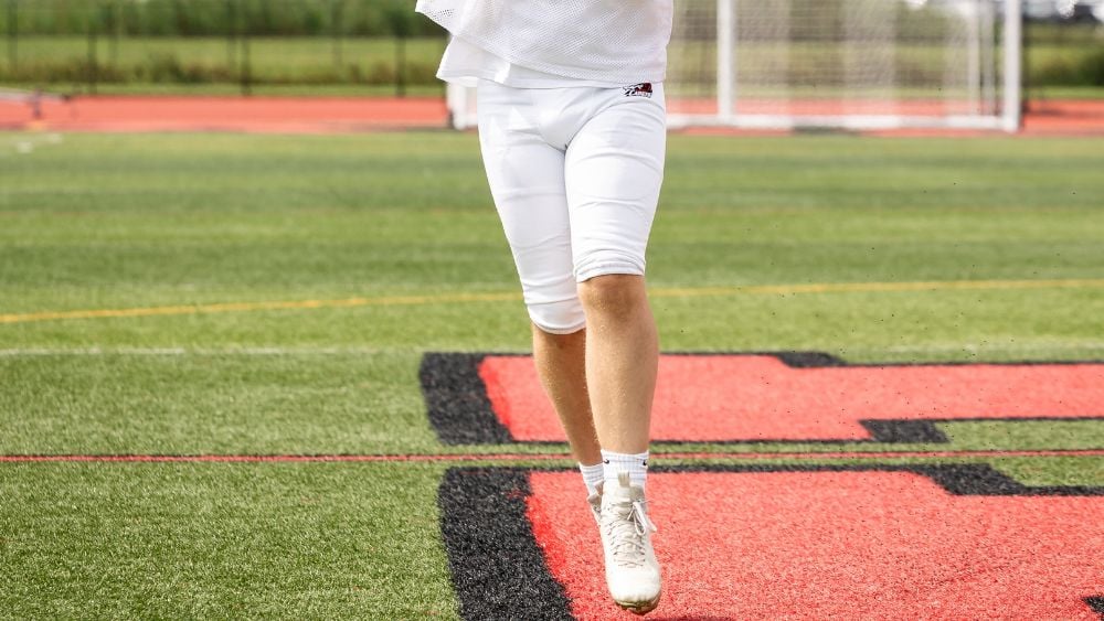 Football player throwing football