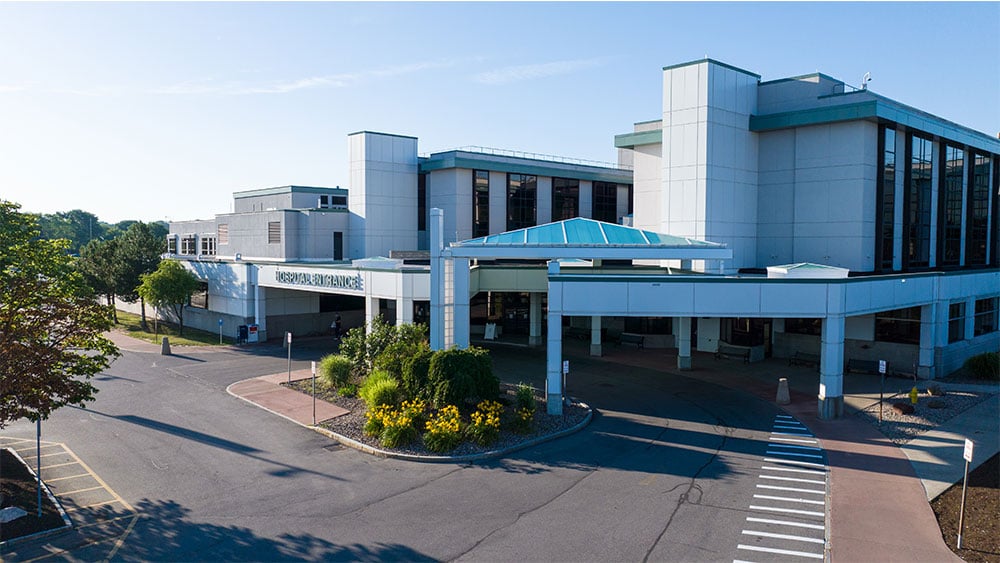 A photo taken from a drone of Unity Hospital with a blue sky