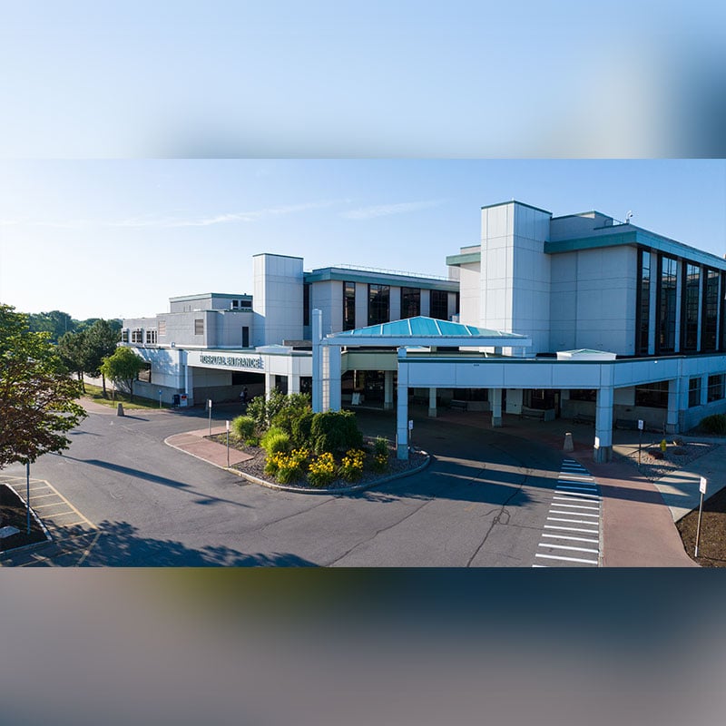 A photo taken from a drone of Unity Hospital with a blue sky