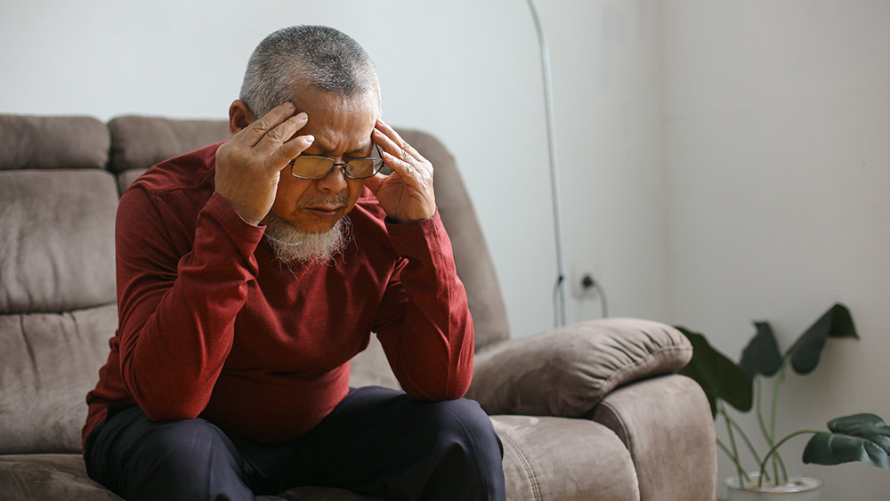 Man with vertigo sitting on couch