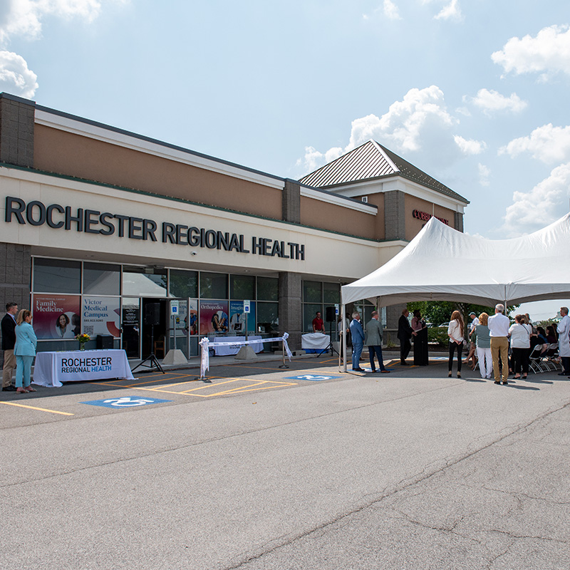 Medical building next to tent under blue sky with white clouds