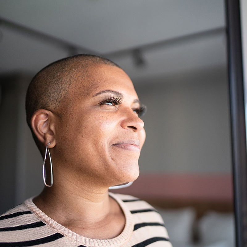 Mature woman contemplating at home