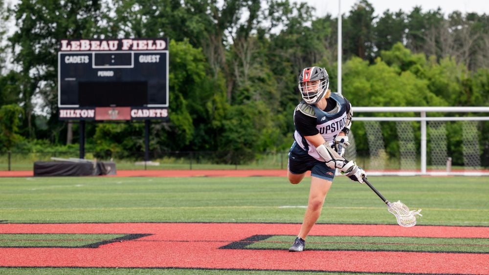 High school lacrosse player practicing on the field