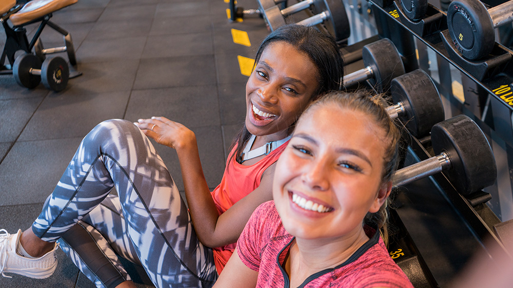 Two women working out together at the gym