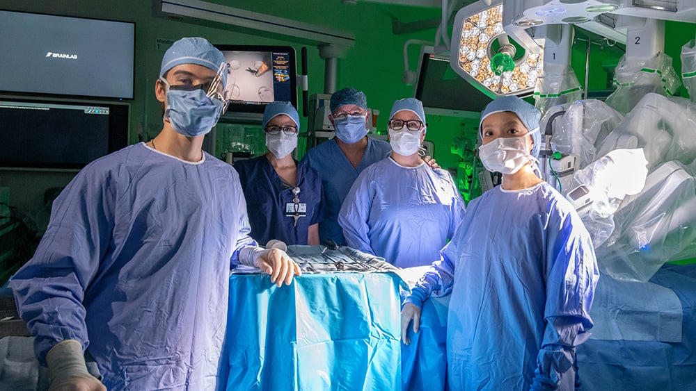 Cardiothoracic surgery team with daVinci robotic surgery system in scrubs