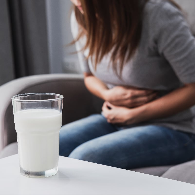 A woman experiencing discomfort after eating something she's allergic to