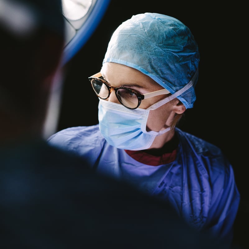 surgeon's masked face in operating room