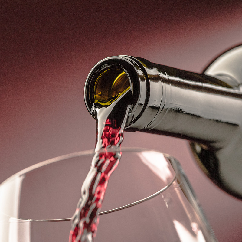 Red wine poured from bottle to glass