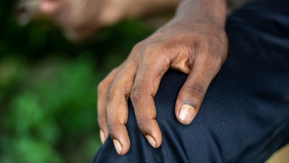 Man holding knee in pain