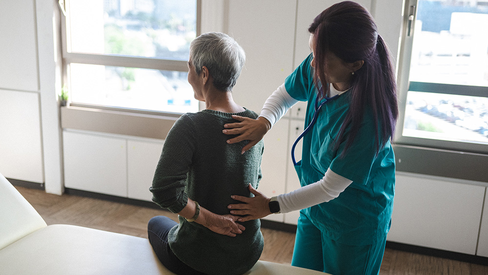 Female provider checking back of female patient