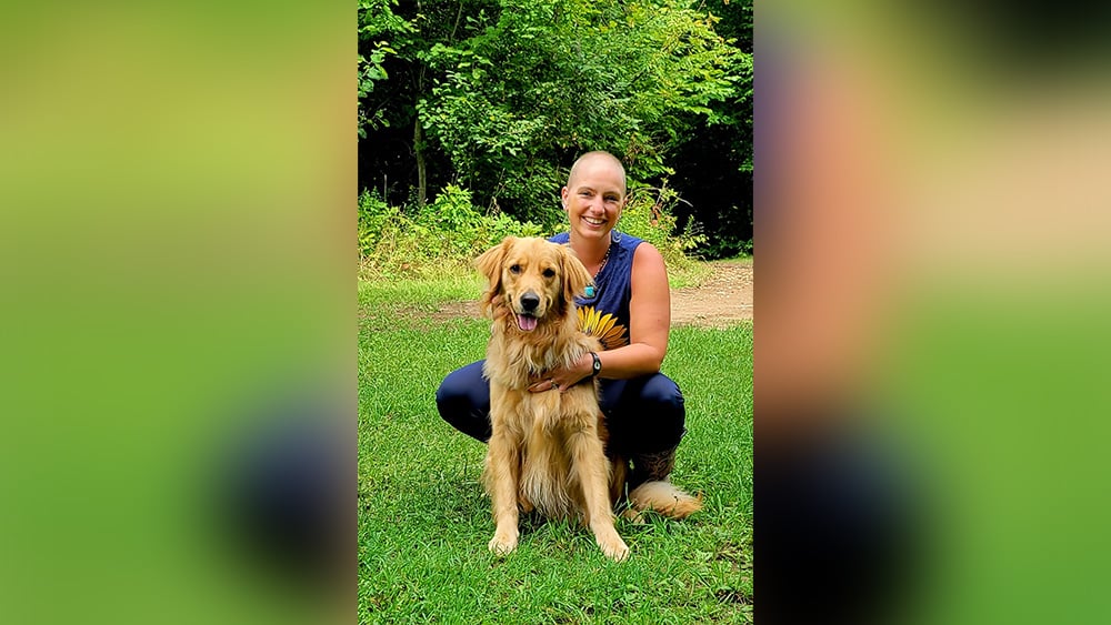 Bald woman and golden retriever outdoors