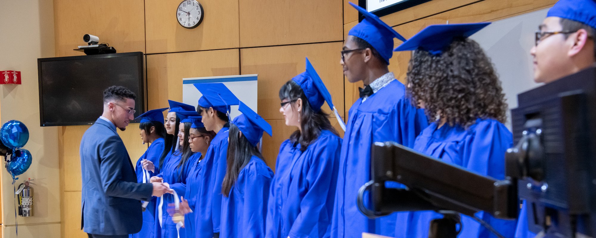 Graduates on stage for the Youth Apprenticeship Program graduation