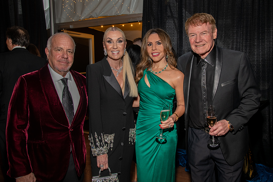 4 gala attendees smiling for photo