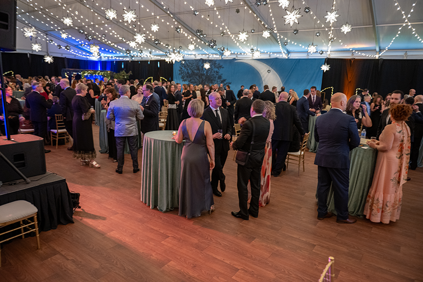 room full of gala attendees standing at tables