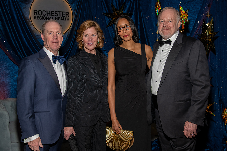 four gala attendees standing and smiling for photo