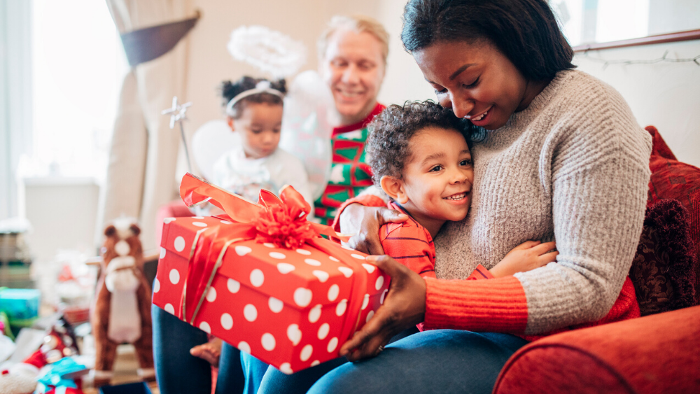 Little kid giving a gift to his mom