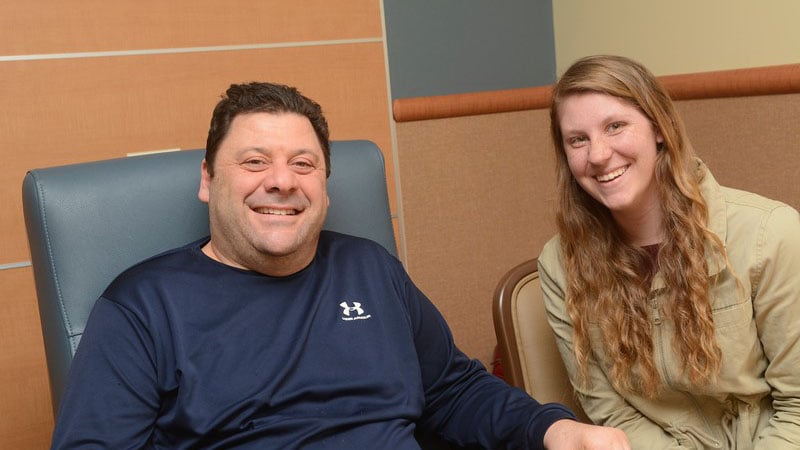 Lenny Arbore and volunteer chatting about his rehabilitation