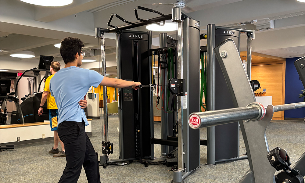 a person works out on a machine in the gym