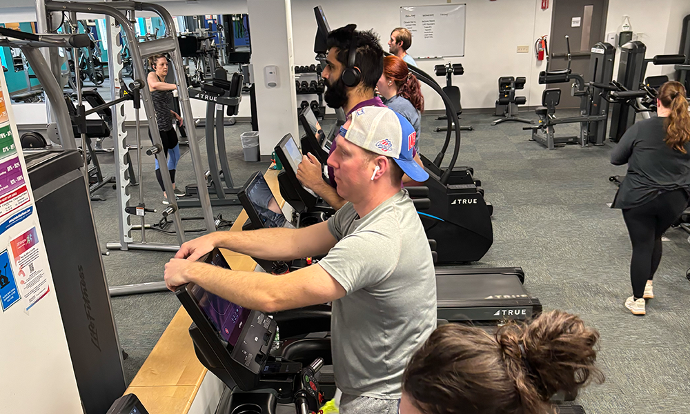 several people work out on treadmills