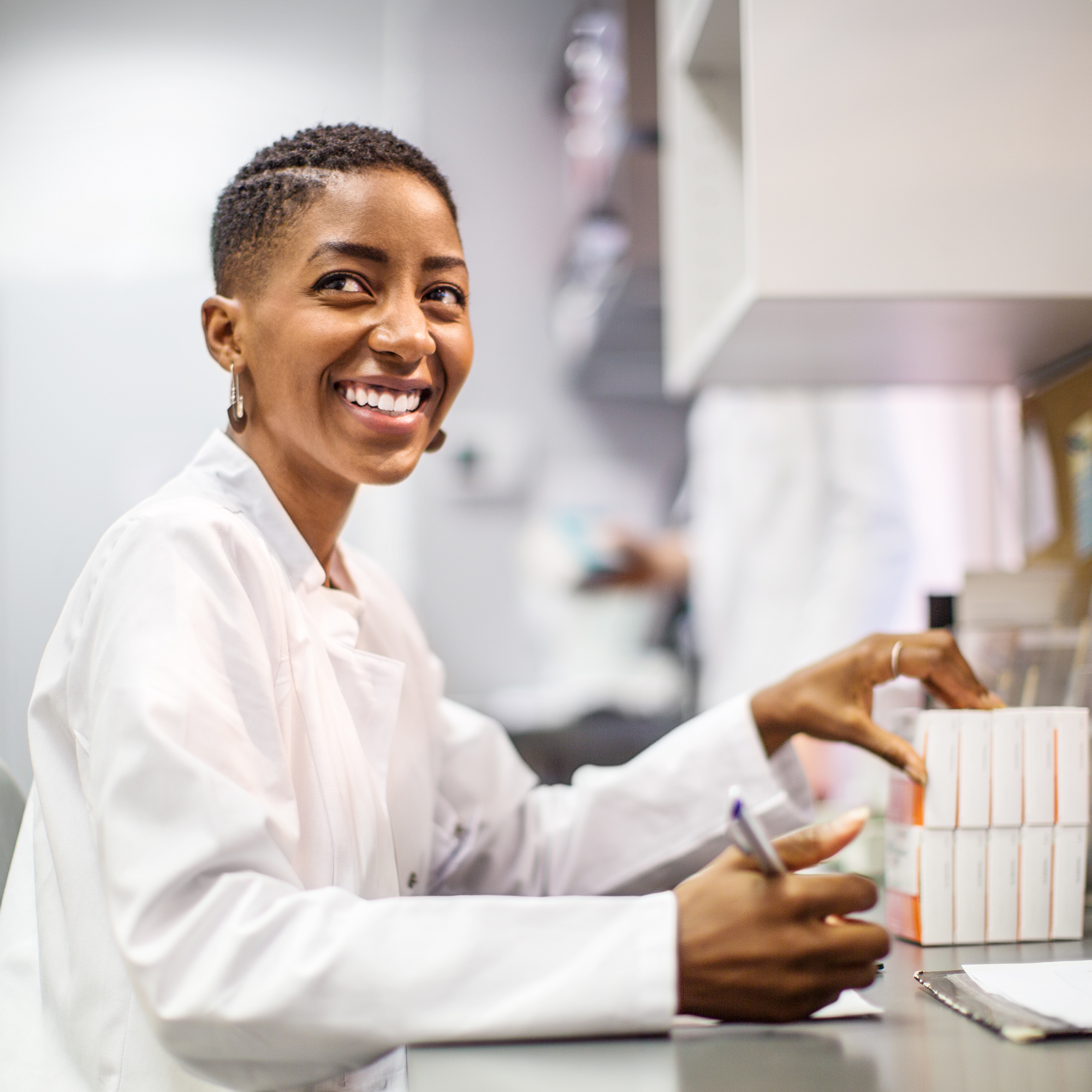 a woman smiles as she does something medical
