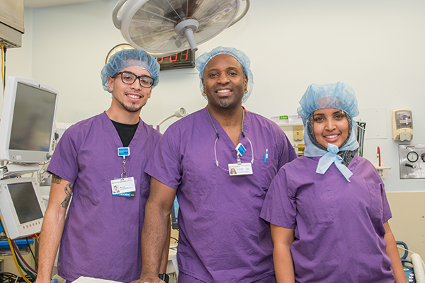 Youth Apprentice students with doctor in scrubs