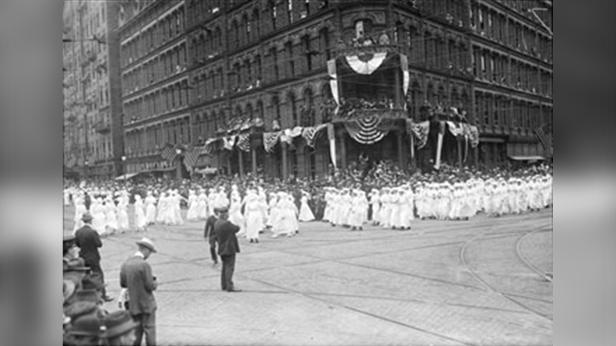 A large contingent of graduate nurses, wearing white dresses and identical caps to signify their unity, marched behind army and navy units in Rochester’s Preparedness Parade on June 10, 1916.